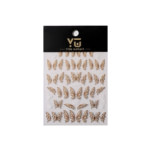 Golden butterfly wing nail art stickers in soft beige and light coffee tones