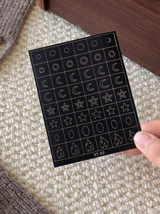 Detailed view of black and gold nail art stickers with stars and moon patterns YT 83