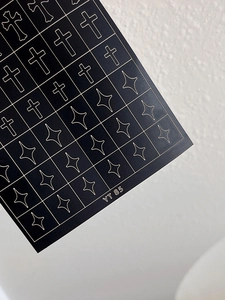 Close-up of YT85 self-adhesive nail stickers with golden cross and star patterns