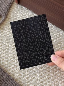 Detailed view of YT 82 self-adhesive nail stickers featuring gold cartoon animal outlines