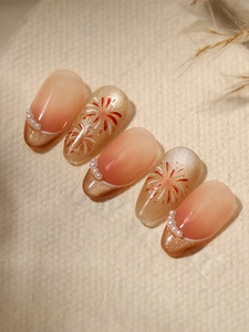 Detail of almond-shaped press-on nails with orange gradient, cat eye effect and pearls