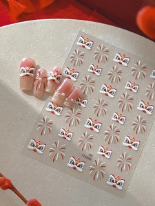 Close-up of Chinese lion dance nail stickers with gold fireworks and pearl accents
