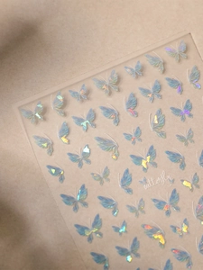 Macro detail of holographic butterfly nail stickers with colorful laser reflective effect
