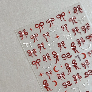 Autocollants nail art avec nœuds rouges, lune et étoiles sur feuilles transparentes