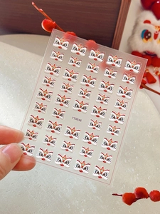 Macro shot of 3D embossed lion dance nail art stickers featuring traditional folk patterns