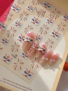 Detail of 3D lion dance and firework nail decals on pink glitter nails with pearls
