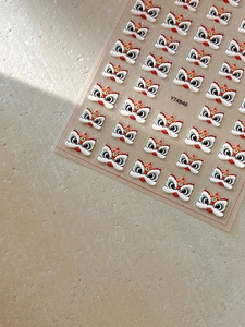 Detailed 3D embossed Chinese lion nail art stickers with vibrant red and yellow patterns