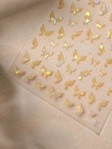 Macro detail of holographic butterfly nail stickers with colorful shell luster effects