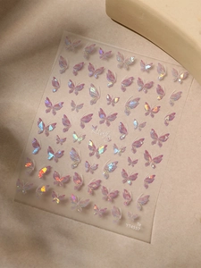 Macro view of holographic butterfly nail stickers with shifting iridescent colors