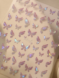 Macro shot of 3D holographic butterfly nail art stickers with purple iridescent glow