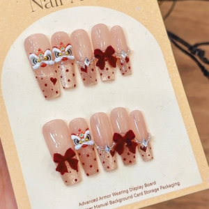 Chinese lion dance press-on nails with red bows and sparkling 3D glitter details