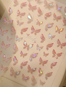 Macro shot of iridescent butterfly nail stickers with a holographic shell shimmer effect