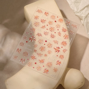Self-adhesive laser fireworks nail stickers with red and white star motifs on artistic stand
