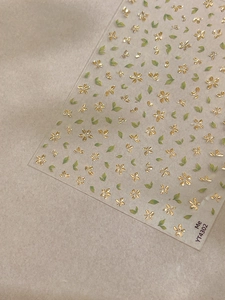Detail of gold foil 3D flower nail stickers with green leaves on YT4302 sheet
