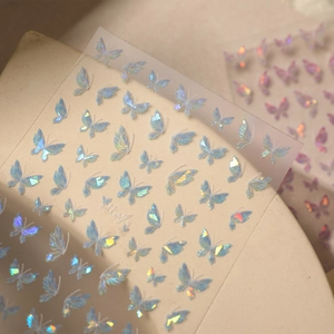 Holographic butterfly nail art stickers with iridescent shell effect and delicate wings