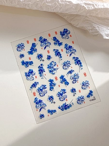 Close-up of YT4826 blue porcelain nail stickers with floral snake designs and lucky seals