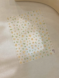 Detail of self-adhesive nail art stickers with gold flowers and green leaves YT4302