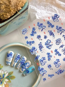 Detail showing blue porcelain snake and floral nail stickers with Chinese lucky seals