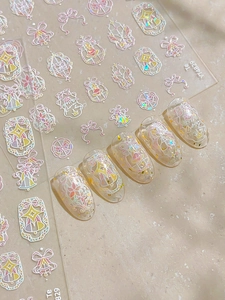 Pink bow nail art stickers with iridescent star designs and example nails display