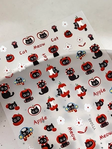 Close-up of cute 3D embossed black cat and red apple nail stickers with flower patterns