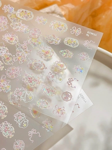 Macro detail of holographic nail stickers with bows and stars for magical DIY crafts