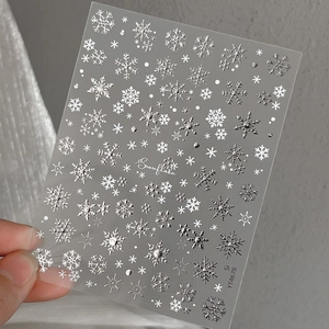 Self-adhesive silver snowflake nail art decals with 3D embossed winter patterns for manicure