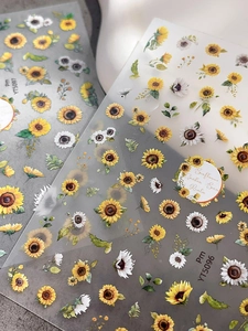 Macro view of watercolor sunflower and daisy nail stickers with self-adhesive backing