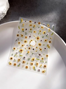 Detail view of yellow sunflower nail art stickers YT5096 on a white decorative plate