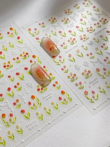 Gros plan d'autocollants pour ongles tulipes 3D avec motifs papillons et rubans décor