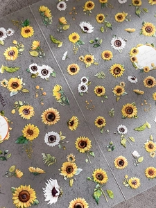 Macro shot of self-adhesive nail art stickers with embossed sunflower and daisy patterns