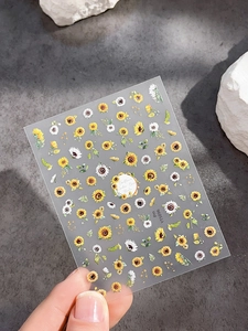 Macro detail of sunflower and daisy nail art stickers with self-adhesive backing YT5096