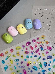 Detail of colorful jelly 3D cartoon nail stickers with slime and eye elements