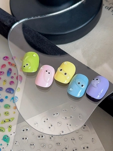 Macro view of jelly cartoon nails with 3D water droplets and cute eye motifs