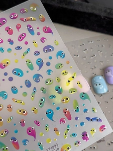Detail of 3D embossed cartoon eye nail stickers with vibrant gradient color effects
