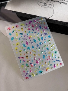 Detailed close-up of colorful 3D slime monster nail stickers on a frosted backing sheet