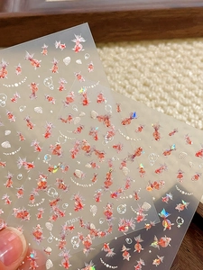 Detailed view of koi fish nail stickers with shimmering shell and star decorative accents