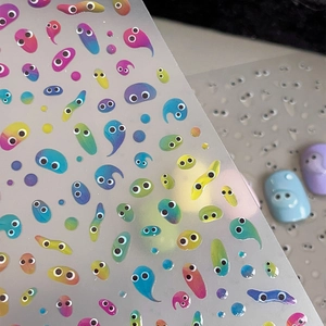 Vibrant cartoon jelly nail stickers with colorful 3D gradient eyes and raindrop slime art