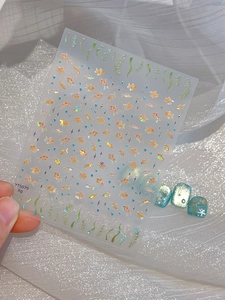 Detailed view of goldfish nail stickers with shimmering gold fish and water plants designs