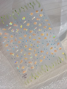 Macro detail of 3D holographic goldfish nail stickers with shimmering star patterns
