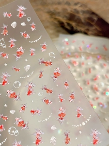 Detailed view of koi fish and seashell nail art stickers with iridescent glitter finish