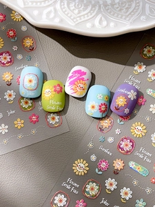 Detail of embossed sunflower nail art stickers with colorful floral and smiley patterns