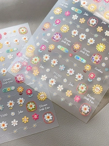 Macro shot of YT5100 relief nail stickers featuring colorful sunflowers and smile faces