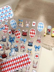 Detail view of Alice Wonderland nail stickers with rabbit and poker motifs on beige textile