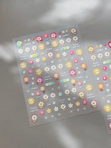 Detail of sunflower nail decals with sunshine text on translucent backing film