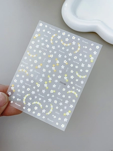 Detailed sheet of floral nail art stickers with white daisies and spring themed words