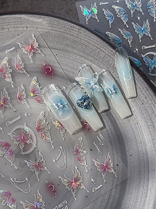Detail of aurora blue butterfly nail stickers with star and moon patterns on coffin nails