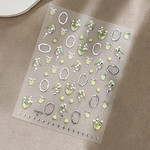 Autocollants nail art muguet élégants avec bordures argentées et nœuds verts
