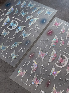 Holographic butterfly wing nail decals with iridescent blue and pink laser effects