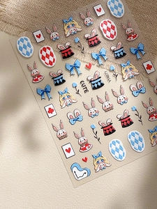 Detail of 3D embossed nail stickers featuring Alice in Wonderland cartoon patterns