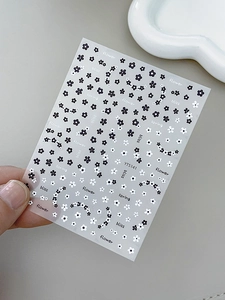 Macro shot of YT5141 nail art stickers featuring black and white embossed flower patterns